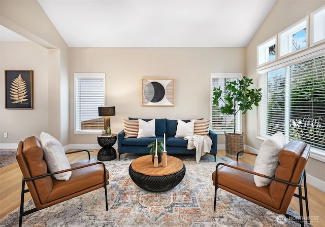 living room with lofted ceiling and light hardwood / wood-style flooring