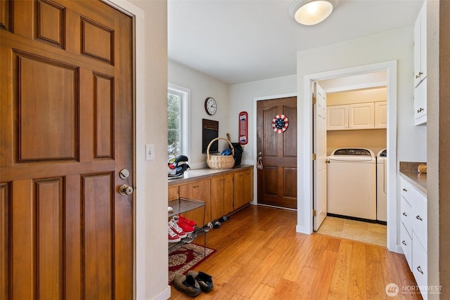 foyer with light hardwood / wood-style flooring and washer and dryer