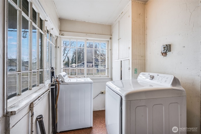 clothes washing area featuring laundry area and washing machine and dryer