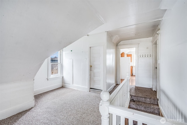 additional living space featuring lofted ceiling and carpet flooring