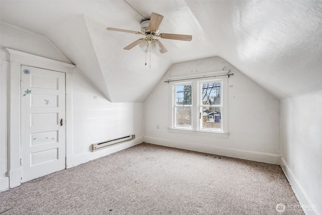 additional living space featuring carpet floors, lofted ceiling, a textured ceiling, and baseboard heating