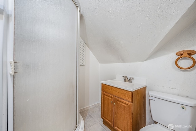 full bathroom featuring a textured ceiling, lofted ceiling, toilet, tile patterned floors, and a stall shower