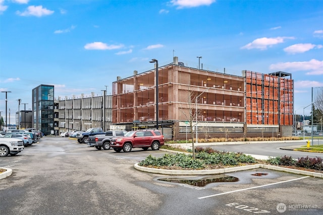 view of property featuring uncovered parking