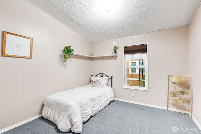 bedroom featuring carpet floors, vaulted ceiling, a textured ceiling, and baseboards