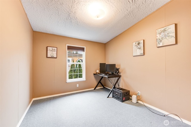 interior space with carpet floors, a textured ceiling, and baseboards