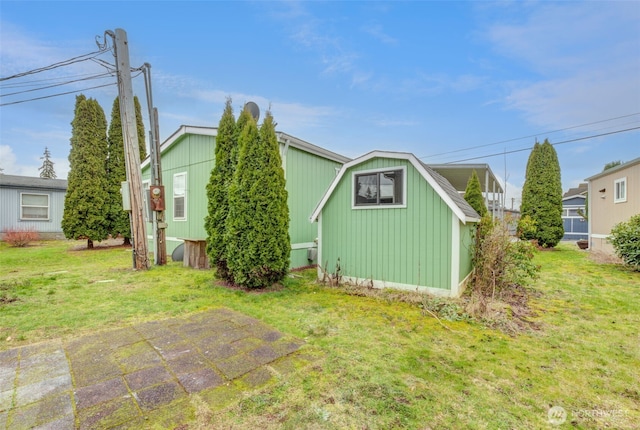 rear view of property featuring a lawn