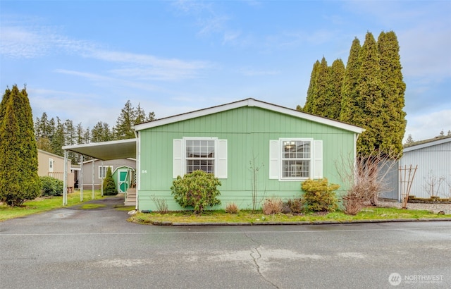 manufactured / mobile home with a carport and driveway