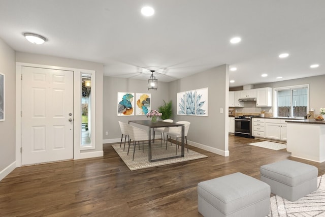 foyer entrance with baseboards, dark wood finished floors, and recessed lighting