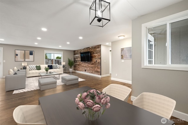 dining area featuring dark wood-style floors, recessed lighting, a fireplace, and baseboards