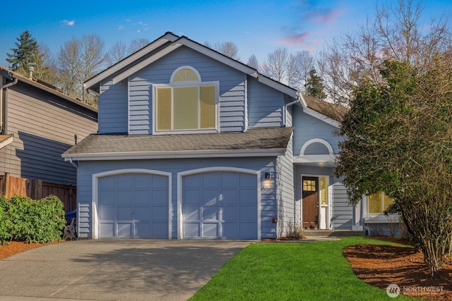 view of front of house with a shingled roof, an attached garage, fence, driveway, and a front lawn