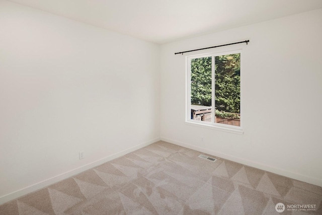 empty room with light carpet, baseboards, and visible vents