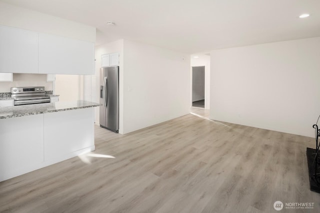 unfurnished living room featuring light wood-style flooring and recessed lighting