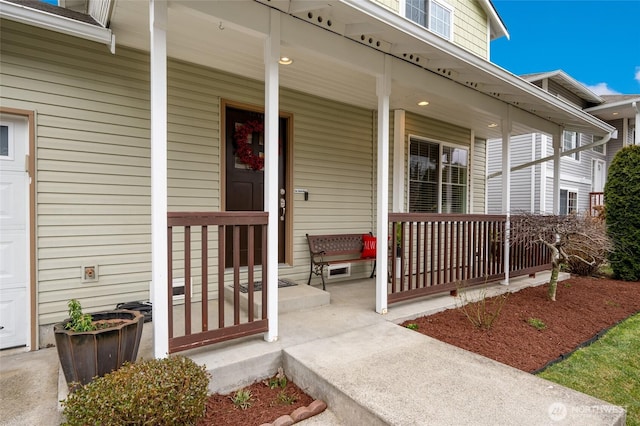 property entrance featuring covered porch and an attached garage