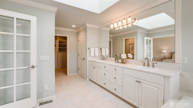 full bath featuring a closet, a skylight, and a sink