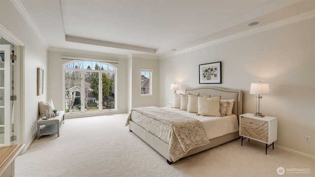 bedroom featuring light carpet, baseboards, ornamental molding, and a raised ceiling