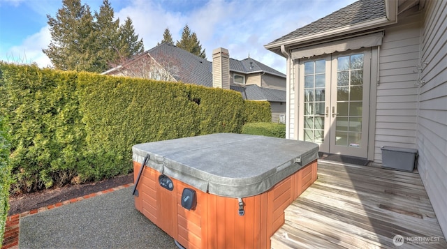 exterior space with french doors and a hot tub