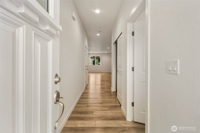 hall with wood-type flooring