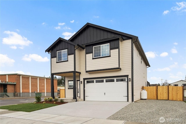 view of front facade featuring driveway, fence, a garage, and board and batten siding