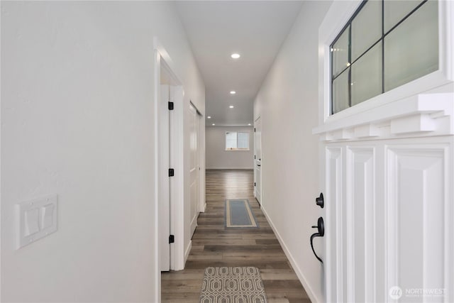 hall featuring recessed lighting, wood finished floors, and baseboards
