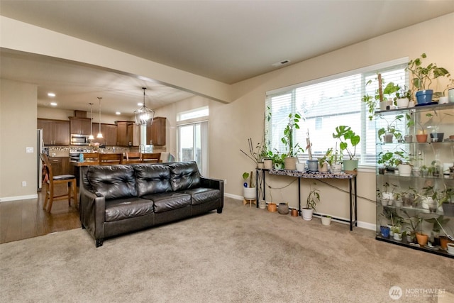 living area featuring light carpet, visible vents, baseboards, and recessed lighting