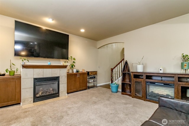 living room with recessed lighting, a fireplace, carpet flooring, baseboards, and stairs