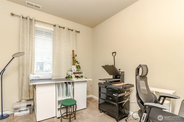 office area with visible vents, light carpet, and baseboards