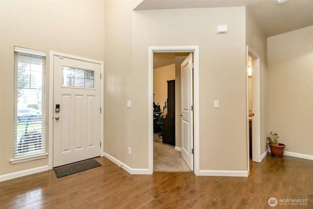 entryway featuring baseboards and wood finished floors