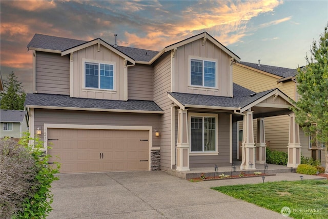 14426 99th Ave SE, Yelm, WA 98597 - view of front of house with covered porch, board and batten siding, an attached garage, driveway, and roof with shingles