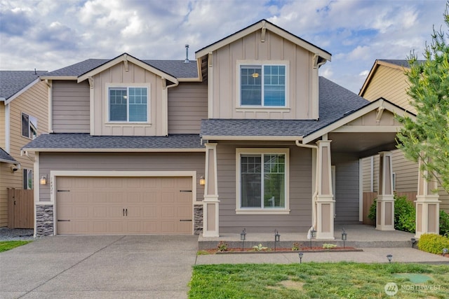14426 99th Ave SE, Yelm, WA 98597 - view of front of property with board and batten siding, a garage, concrete driveway, a porch, and roof with shingles