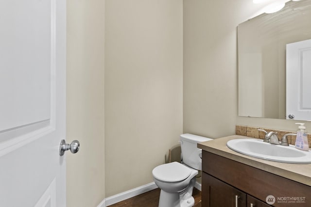 14426 99th Ave SE, Yelm, WA 98597 - bathroom featuring toilet, vanity, wood finished floors, and baseboards