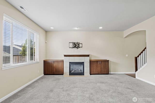 14426 99th Ave SE, Yelm, WA 98597 - unfurnished living room with carpet, a fireplace, baseboards, stairs, and recessed lighting