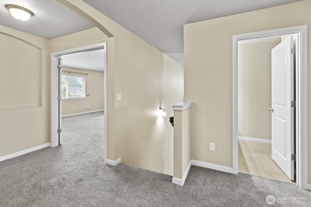 14426 99th Ave SE, Yelm, WA 98597 - corridor with carpet flooring, arched walkways, an upstairs landing, and baseboards