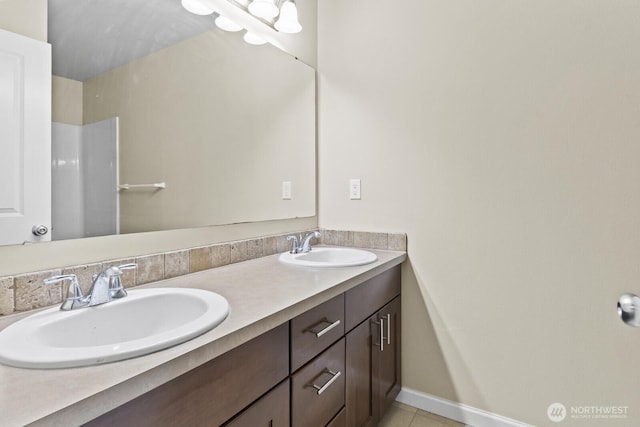 14426 99th Ave SE, Yelm, WA 98597 - bathroom featuring double vanity, tile patterned floors, and baseboards