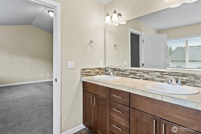 14426 99th Ave SE, Yelm, WA 98597 - full bath with double vanity, decorative backsplash, baseboards, and vaulted ceiling