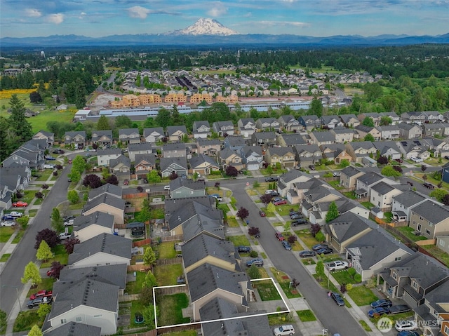 14426 99th Ave SE, Yelm, WA 98597 - aerial view of residential area featuring a mountain backdrop and property parcel outlined