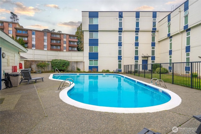 pool featuring a patio and fence