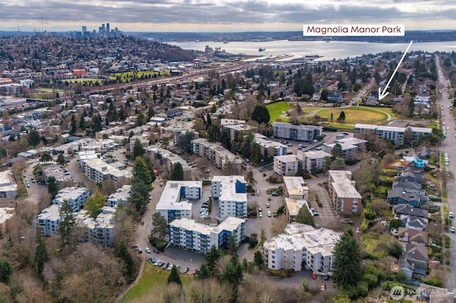 drone / aerial view featuring a view of city and a water view