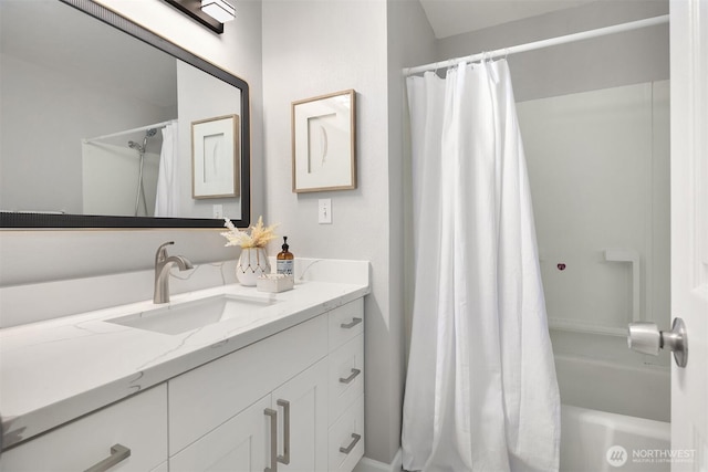 bathroom featuring shower / bath combo and vanity