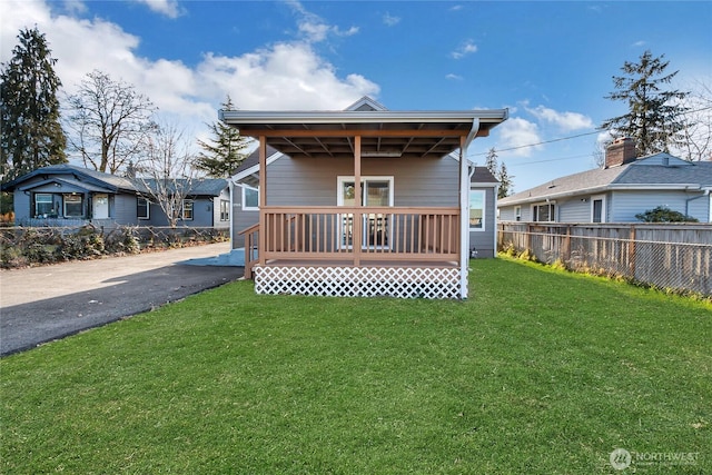 rear view of house with a yard