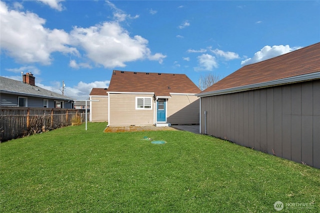 rear view of property featuring a lawn