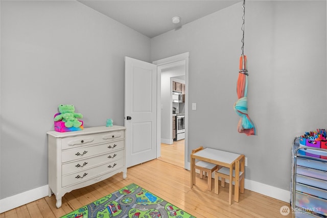 playroom with light hardwood / wood-style flooring