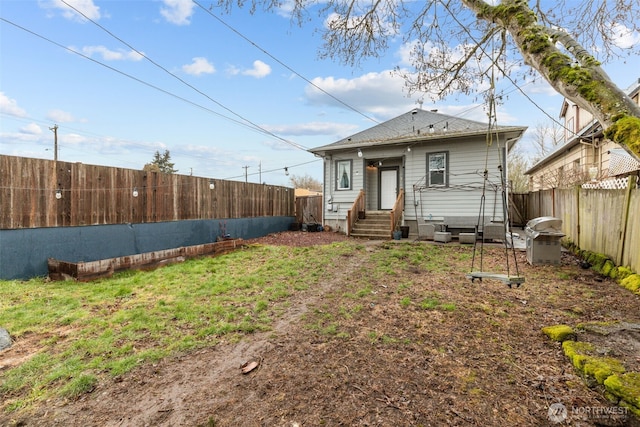 rear view of property with a yard