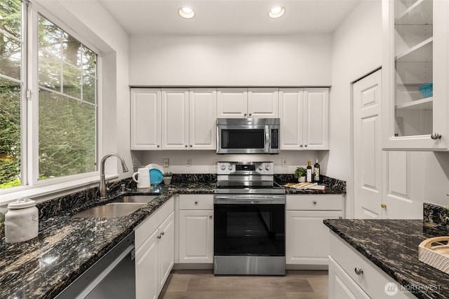 kitchen with sink, white cabinets, and stainless steel appliances