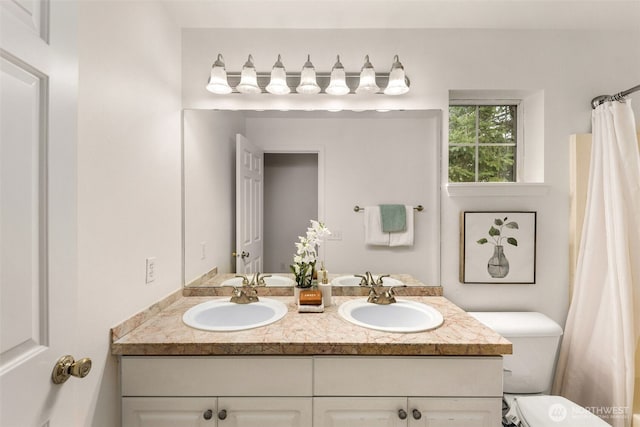 bathroom featuring toilet and vanity