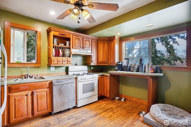 3416 Claremont Ave S, Seattle, WA 98144 - kitchen with dishwasher, a sink, under cabinet range hood, white range with gas stovetop, and light wood-style flooring