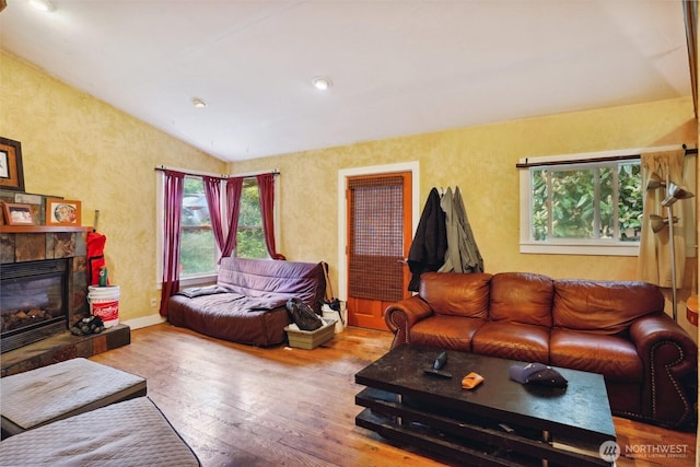 3416 Claremont Ave S, Seattle, WA 98144 - living area with wood-type flooring, a tile fireplace, and lofted ceiling