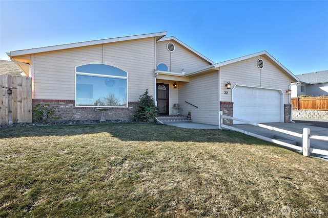 single story home with fence, concrete driveway, a front yard, a garage, and brick siding