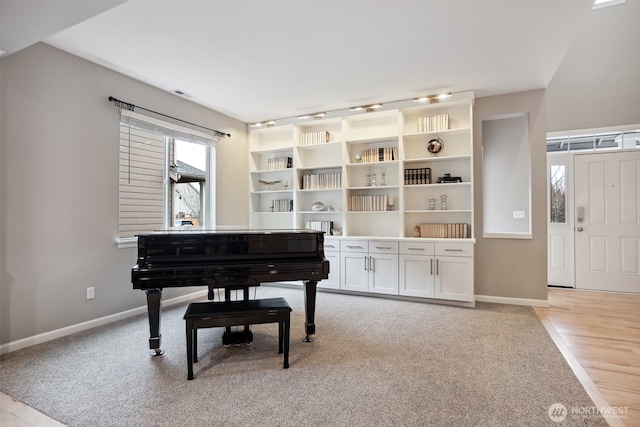 living area with light carpet and baseboards