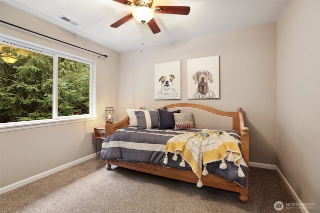 carpeted bedroom featuring visible vents, ceiling fan, and baseboards