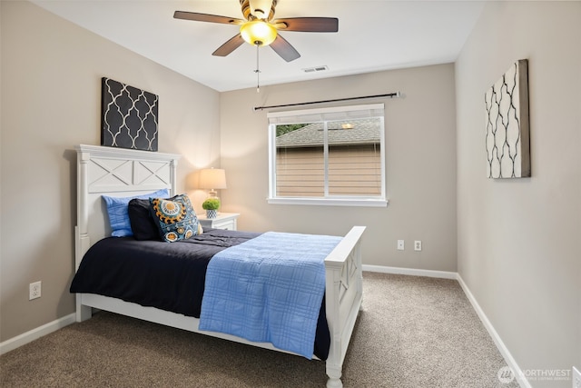 carpeted bedroom featuring baseboards, visible vents, and ceiling fan